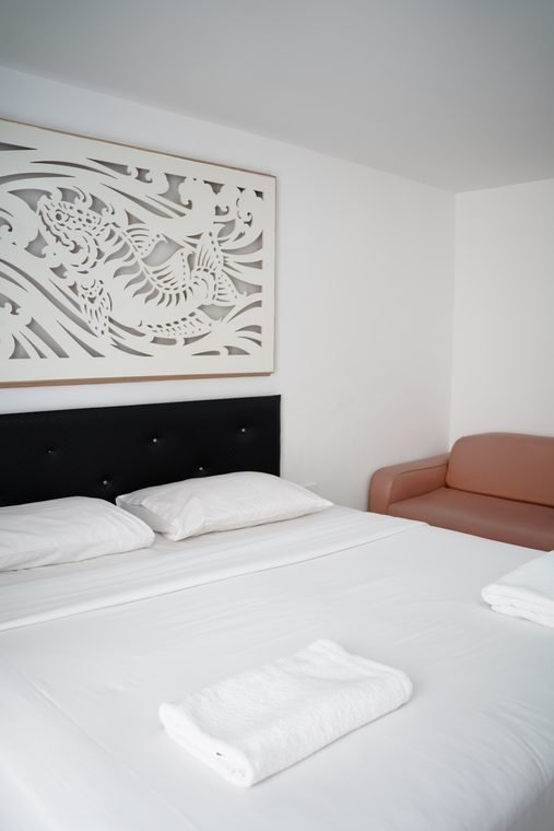 Deluxe room with double bed and armchair