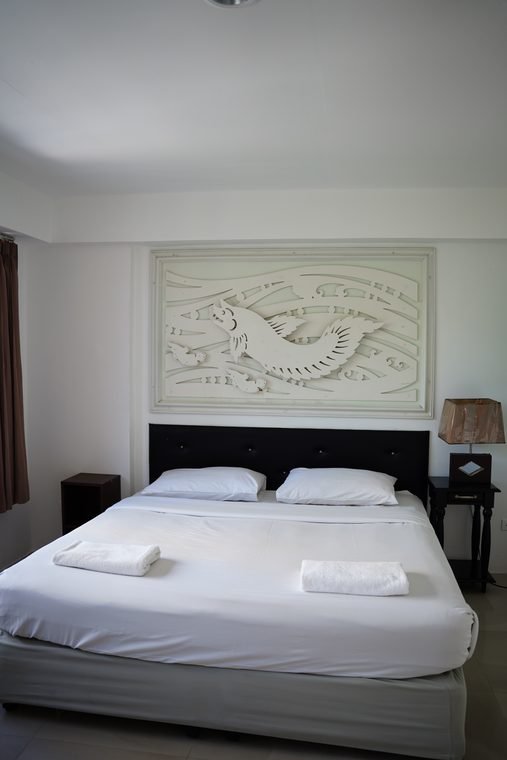 Suite bedroom with carved wall panel